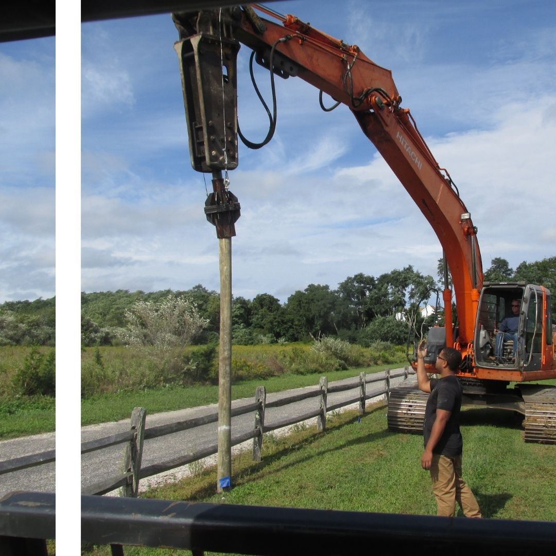 a fence post being lifted into place by a crane