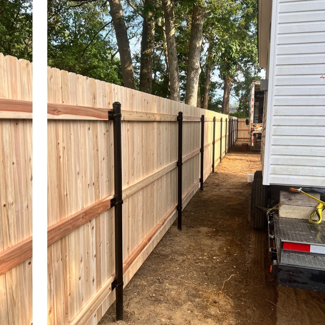a wooden fence along a house