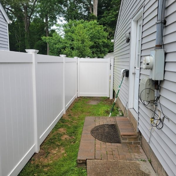 newly installed PVC fence along home