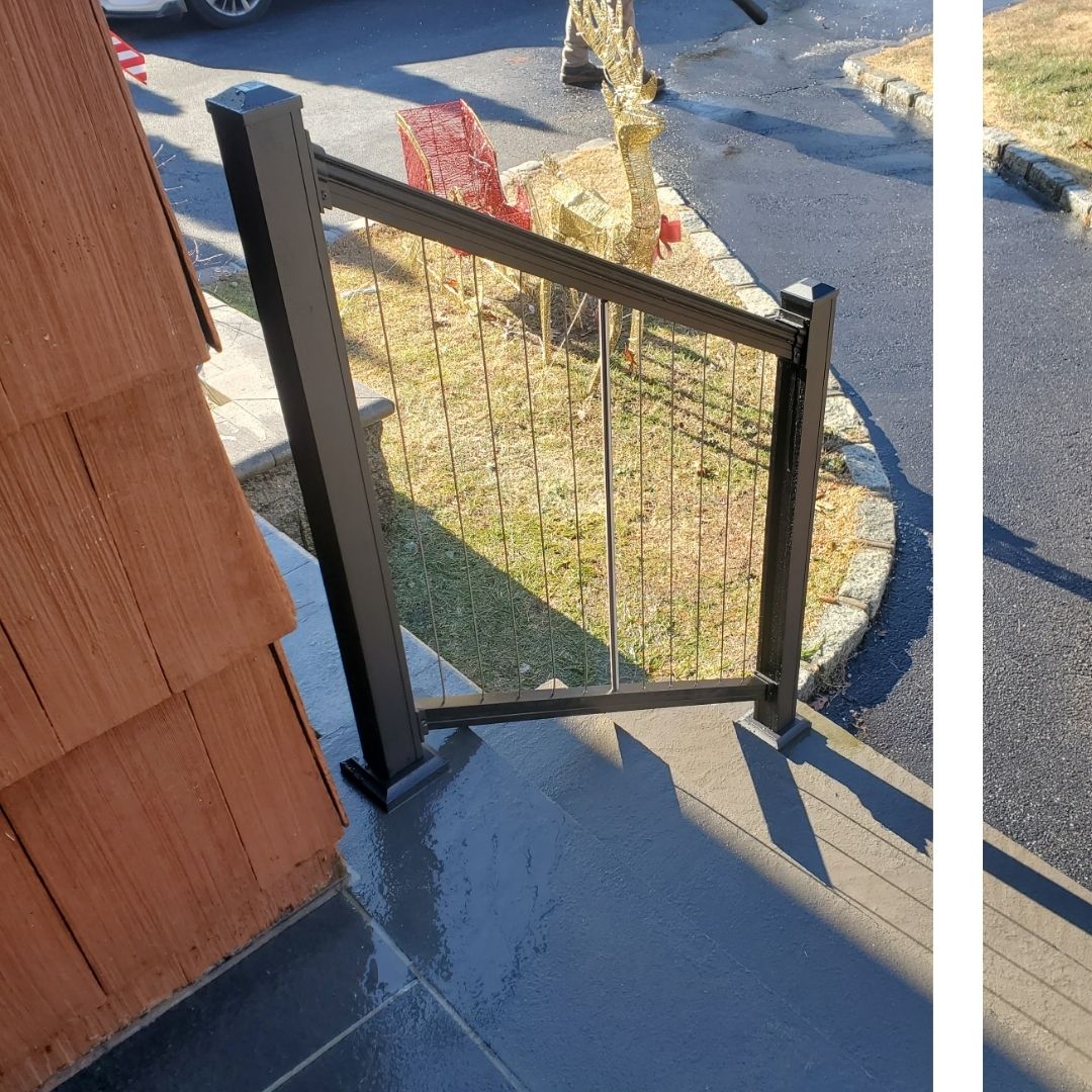 Modern black cable railing system for outdoor stairs installed by a local fence company
