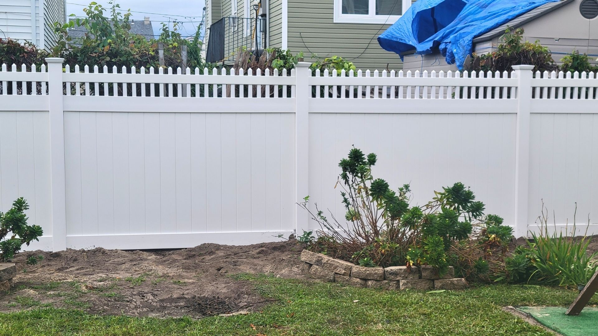 a white fence in a backyard