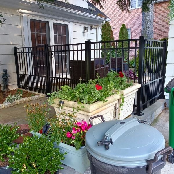 a black aluminum fence surrounding a patio