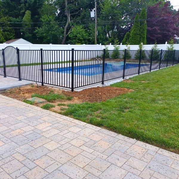 an aluminum fence surrounding a pool
