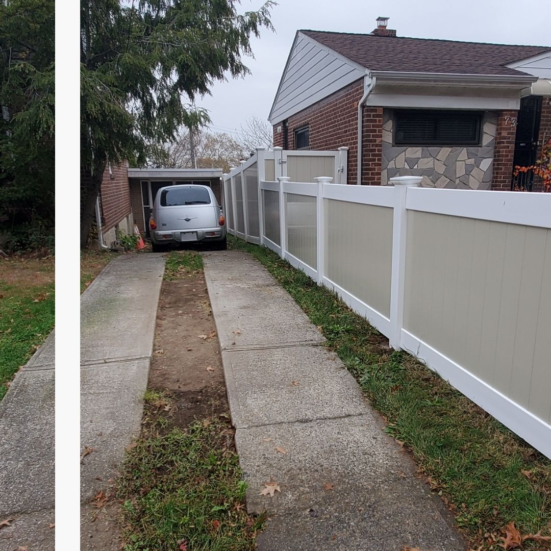 long fence dividing yard from driveway