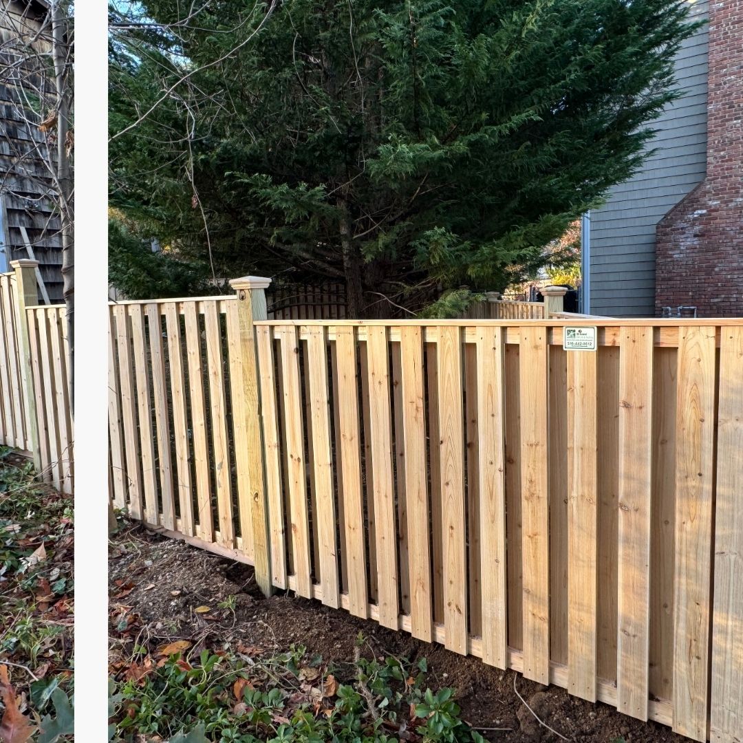 Close-up view of a recently installed alternating vertical slat wood fence (shadowbox style) with solid wooden posts, defining a property line in Brooklyn Heights.
