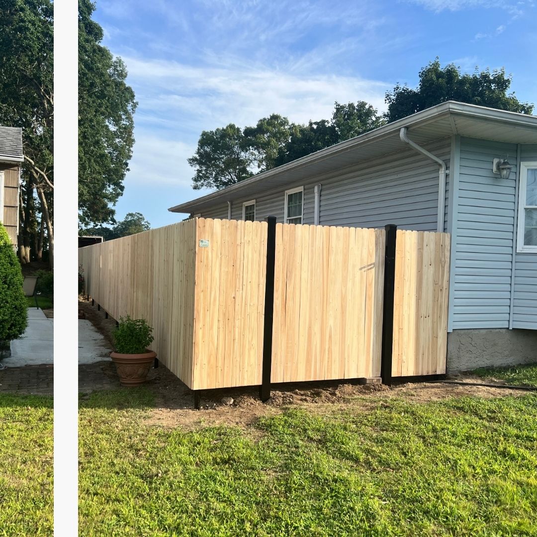 wood fence installation featuring strong black steel posts, enclosing a residential backyard in Brooklyn Heights, NY