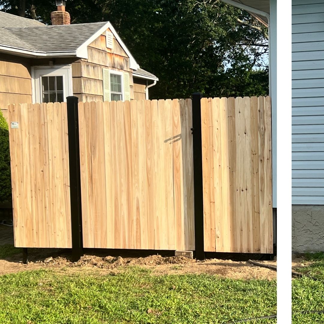 natural wood stockade privacy fence with durable black metal posts, enclosing a residential yard